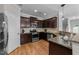 Stylish kitchen features stainless steel appliances, granite countertops, and dark wood cabinetry at 2057 Tanners Mill Dr, Durham, NC 27703