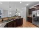 Bright kitchen with stainless steel appliances, granite countertops and open view to living area at 2057 Tanners Mill Dr, Durham, NC 27703