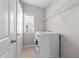 Bright laundry room with a white washer and dryer, shelving, and a window for natural light at 2057 Tanners Mill Dr, Durham, NC 27703
