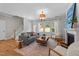 Bright living room with a fireplace and hardwood floors, with a view of the staircase at 2057 Tanners Mill Dr, Durham, NC 27703