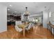 Open living space with hardwood floors and connecting kitchen and dining area at 2057 Tanners Mill Dr, Durham, NC 27703