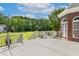 Inviting back deck with outdoor seating, perfect for enjoying the scenic view of the well-manicured lawn and lush greenery at 206 W Stoneybrook Ct, Benson, NC 27504