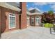 Stylish back deck with charming brick details, offering a cozy outdoor space with scenic views of the beautifully landscaped backyard at 206 W Stoneybrook Ct, Benson, NC 27504