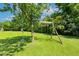 Lovely backyard play area featuring a swing set and climbing rope, providing a fun and engaging space for children at 206 W Stoneybrook Ct, Benson, NC 27504