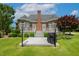 Backyard view of a deck with an outdoor kitchen, beautiful landscaping, and mature trees at 206 W Stoneybrook Ct, Benson, NC 27504