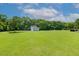 Expansive green lawn and mature trees provide a serene backdrop to this home at 206 W Stoneybrook Ct, Benson, NC 27504