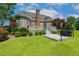 Expansive backyard featuring mature landscaping, hardscape patio and grilling area at 206 W Stoneybrook Ct, Benson, NC 27504