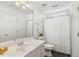 This white bathroom offers a shower with tub, a marble vanity, and updated fixtures at 206 W Stoneybrook Ct, Benson, NC 27504