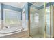 Clean bathroom with tub, separate glass shower, and a window for plenty of natural light at 206 W Stoneybrook Ct, Benson, NC 27504