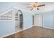 Bedroom boasting laminate flooring, arched entry to closet, and ceiling fan at 206 W Stoneybrook Ct, Benson, NC 27504