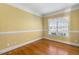 Bright bedroom with hardwood floors, a large window, and neutral wall color at 206 W Stoneybrook Ct, Benson, NC 27504