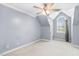 Neutral bedroom offering an arched window, and a ceiling fan at 206 W Stoneybrook Ct, Benson, NC 27504