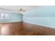Spacious bonus room with hardwood floors, light blue walls, and a ceiling fan provides ample space for various activities at 206 W Stoneybrook Ct, Benson, NC 27504