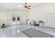 Spacious room with vaulted ceilings, skylight, fan, and French doors leading to the backyard at 206 W Stoneybrook Ct, Benson, NC 27504