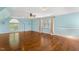A spacious bonus room with hardwood floors, two windows, and blue walls at 206 W Stoneybrook Ct, Benson, NC 27504