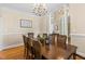 Traditional dining room with hardwood floors, ornate chandelier, and space for large gatherings at 206 W Stoneybrook Ct, Benson, NC 27504