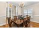 Formal dining room with hardwood floors, elegant lighting, and classic decor at 206 W Stoneybrook Ct, Benson, NC 27504