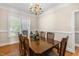 Formal dining room with hardwood floors, a window, and classic decor at 206 W Stoneybrook Ct, Benson, NC 27504