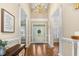 Elegant foyer with hardwood floors, white columns, and a decorative chandelier at 206 W Stoneybrook Ct, Benson, NC 27504