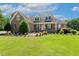 Beautiful brick home with manicured lawn, lush landscaping, and classic design elements at 206 W Stoneybrook Ct, Benson, NC 27504