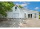 Detached garage features three bays, an attached workshop, and an exterior door and windows at 206 W Stoneybrook Ct, Benson, NC 27504