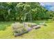 Picturesque garden area featuring raised garden beds, perfect for cultivating fresh herbs, vegetables, and flowers at 206 W Stoneybrook Ct, Benson, NC 27504