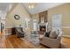 Spacious living room with a cozy brick fireplace, hardwood floors, and natural light at 206 W Stoneybrook Ct, Benson, NC 27504