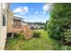 Landscaped backyard with a wooden deck and stairs at 210 Strolling Way, Durham, NC 27707