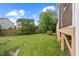 Well maintained backyard with a wooden fence and neighboring houses at 210 Strolling Way, Durham, NC 27707