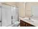 A well-lit bathroom with a glass-enclosed shower, a white toilet, and a wood vanity at 210 Strolling Way, Durham, NC 27707