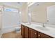 Bathroom with double sink vanity, toilet, and tub with shower at 210 Strolling Way, Durham, NC 27707