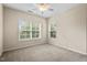 A bright bedroom with neutral carpeting and a large window overlooking a green landscape at 210 Strolling Way, Durham, NC 27707