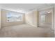 Large bonus room with neutral carpeting and lots of natural light from multiple windows at 210 Strolling Way, Durham, NC 27707