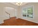 Spacious dining room with hardwood floors and large window, adjacent to the staircase at 210 Strolling Way, Durham, NC 27707
