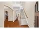 Elegant foyer featuring hardwood floors and a staircase leading to the upper level at 210 Strolling Way, Durham, NC 27707