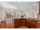 Open concept living space with kitchen island leading to the back deck at 210 Strolling Way, Durham, NC 27707