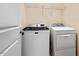 Laundry room with a washer and dryer and wire shelving at 210 Strolling Way, Durham, NC 27707