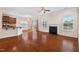 Cozy living room featuring hardwood floors, a fireplace, and open access to the kitchen at 210 Strolling Way, Durham, NC 27707
