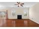 Inviting living room with hardwood floors, a fireplace, and glass doors leading to the outdoor deck at 210 Strolling Way, Durham, NC 27707