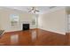 Bright living room with a fireplace, hardwood floors, and natural light from large windows at 210 Strolling Way, Durham, NC 27707