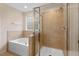Well-lit main bathroom includes a tub, stand up shower with glass door, and tile accents at 210 Strolling Way, Durham, NC 27707