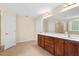 A main bathroom with dual sinks, a large mirror, and tile flooring at 210 Strolling Way, Durham, NC 27707