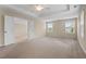 Large main bedroom with neutral carpeting, overhead fan, and ensuite entrance at 210 Strolling Way, Durham, NC 27707