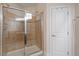 Bathroom showing a glass-enclosed shower with tile walls and a built-in seat at 2122 Aventon Ln, Morrisville, NC 27560