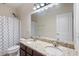 Bathroom featuring a double vanity with granite countertops and a shower/tub combo at 2122 Aventon Ln, Morrisville, NC 27560