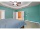 Spacious bedroom with tray ceilings and carpeted floors, providing a cozy and inviting atmosphere at 2122 Aventon Ln, Morrisville, NC 27560