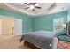 Bedroom with ceiling fan, a window, and a door with stairs, showcasing a cozy layout at 2122 Aventon Ln, Morrisville, NC 27560