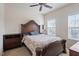 Traditional-style bedroom with a large bed, ceiling fan, and natural light from two windows at 2122 Aventon Ln, Morrisville, NC 27560