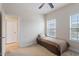 Bedroom featuring a ceiling fan and two windows, providing ample natural light at 2122 Aventon Ln, Morrisville, NC 27560