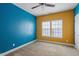 Bedroom featuring vibrant yellow and blue walls, ceiling fan, and natural lighting at 2122 Aventon Ln, Morrisville, NC 27560